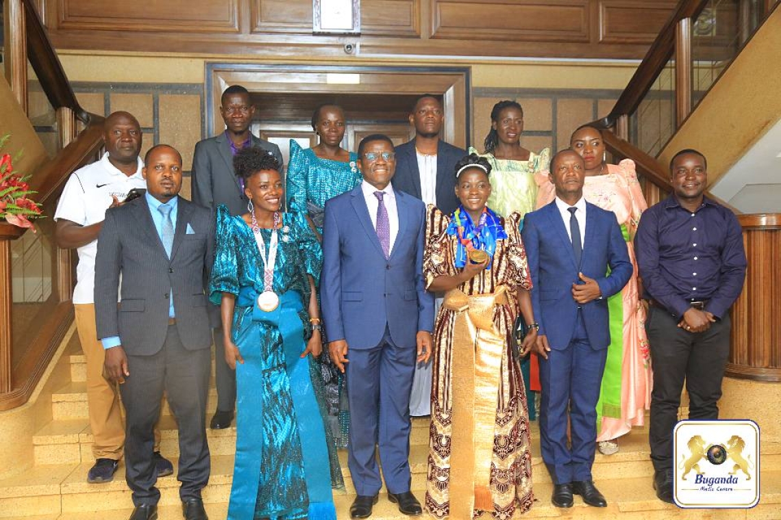 Katikkiro, Halima Nakaayi, Winnie Nanyondo, and Hon. Robert Sserwanga pose for a group photo with other attendees